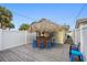 Outdoor tiki bar with blue stools on a grey deck at 13426 Gulf Blvd, Madeira Beach, FL 33708