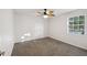 Bright bedroom with ceiling fan and carpeted floor at 12141 Spartan Way # 103, Hudson, FL 34667