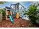 Backyard featuring a play structure, mature landscaping, and plenty of space for recreation at 6619 Livingston N Ave, St Petersburg, FL 33702