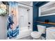 Bathroom featuring white subway tile, modern fixtures, and vibrant blue walls at 6619 Livingston N Ave, St Petersburg, FL 33702