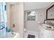 Bathroom featuring a tiled shower and white vanity with granite countertop at 6619 Livingston N Ave, St Petersburg, FL 33702