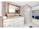 Bathroom featuring a large mirror, white vanity, and tiled floors at 6619 Livingston N Ave, St Petersburg, FL 33702