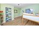 Bright bedroom featuring light green walls and wood-look floors at 6619 Livingston N Ave, St Petersburg, FL 33702