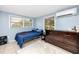 Bedroom showcasing neutral paint, tiled floors, and an air conditioning unit at 6619 Livingston N Ave, St Petersburg, FL 33702