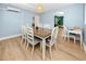 Dining room featuring wood floors, blue walls, and a decorative light fixture at 6619 Livingston N Ave, St Petersburg, FL 33702