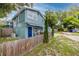 Side view of a two-story home showing the exterior features and side yard at 6619 Livingston N Ave, St Petersburg, FL 33702