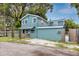 Side view of a two-story home showing the exterior features and landscaping at 6619 Livingston N Ave, St Petersburg, FL 33702