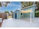 View of the detached garage and rear patio with awning, showing the backyard and a privacy fence at 6619 Livingston N Ave, St Petersburg, FL 33702