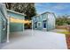 View of the rear of the home featuring a concrete patio with awning and an adjacent outbuilding or garage at 6619 Livingston N Ave, St Petersburg, FL 33702