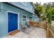 Inviting front entry with a stylish blue door and a cozy seating area at 6619 Livingston N Ave, St Petersburg, FL 33702