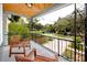 Inviting front porch with wooden chairs and a view of the quiet street at 6619 Livingston N Ave, St Petersburg, FL 33702