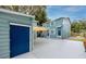 View of the rear of the home featuring a detached garage and concrete patio with awning at 6619 Livingston N Ave, St Petersburg, FL 33702