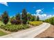 Curving concrete pathway, lush landscaping at 9 Pelican Pl, Belleair, FL 33756