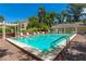 Community pool with brick patio and pergola at 9 Pelican Pl, Belleair, FL 33756