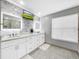 Elegant bathroom with double vanity, marble counters, and large mirror at 12506 Ashdown Dr, Odessa, FL 33556
