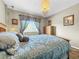 Cozy bedroom with wood floors and unique chandelier at 12506 Ashdown Dr, Odessa, FL 33556