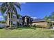 Two-story home with landscaped yard and palm trees at 12506 Ashdown Dr, Odessa, FL 33556