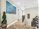 Luminous hallway with hardwood floors and modern art at 12506 Ashdown Dr, Odessa, FL 33556