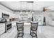 Kitchen with white cabinets, island, and stainless steel appliances at 12506 Ashdown Dr, Odessa, FL 33556