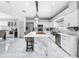 Modern kitchen featuring white cabinets, marble countertops, and a large island at 12506 Ashdown Dr, Odessa, FL 33556