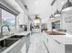 Spacious kitchen boasts modern white cabinets, large island, and stainless steel appliances at 12506 Ashdown Dr, Odessa, FL 33556