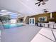 Large screened-in pool and patio area with built-in grill at 12506 Ashdown Dr, Odessa, FL 33556
