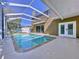 Inviting screened pool and patio with outdoor kitchen at 12506 Ashdown Dr, Odessa, FL 33556