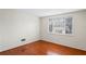 Simple bedroom with wood flooring and large window at 3600 Landale Dr, Holiday, FL 34691