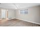 Simple bedroom with wood-look floors and large window at 3600 Landale Dr, Holiday, FL 34691