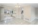 Open dining room with view into the kitchen and access to a screened patio at 3600 Landale Dr, Holiday, FL 34691