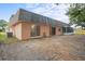 Back of house with yard and screened porch at 3600 Landale Dr, Holiday, FL 34691