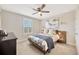 This bedroom features a modern bed frame and a window with modern shutters at 16462 Courtyard Loop, Land O Lakes, FL 34638
