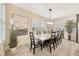 Bright dining room with plantation shutters, stylish decor, and a large dining table at 16462 Courtyard Loop, Land O Lakes, FL 34638