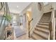 Bright foyer with views of the stairway, half bath, and decorator-designed wall at 16462 Courtyard Loop, Land O Lakes, FL 34638