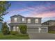 Charming two-story home with well-manicured landscaping and a three-car garage at 16462 Courtyard Loop, Land O Lakes, FL 34638