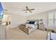 A beautifully appointed main bedroom features a ceiling fan and neutral tones, creating a relaxing atmosphere at 16462 Courtyard Loop, Land O Lakes, FL 34638