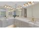 Double vanity bathroom with large mirrors and updated fixtures at 4251 Preserve Pl, Palm Harbor, FL 34685