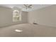 Spacious bedroom with large window and ceiling fan at 4251 Preserve Pl, Palm Harbor, FL 34685