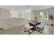 Bright dining room with a dark wood table and six light-colored chairs at 4251 Preserve Pl, Palm Harbor, FL 34685