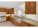 Kitchen boasts wood cabinets, granite counters, and double sinks at 4251 Preserve Pl, Palm Harbor, FL 34685