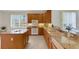 Kitchen with wood cabinets, granite countertops, and an island at 4251 Preserve Pl, Palm Harbor, FL 34685
