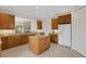 Kitchen with wood cabinets, granite countertops, and an island at 4251 Preserve Pl, Palm Harbor, FL 34685