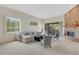 Bright living room featuring an L-shaped sofa, fireplace and views to backyard at 4251 Preserve Pl, Palm Harbor, FL 34685
