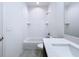 White tiled bathroom with bathtub and shower at 2404 1/2 E Chelsea, Tampa, FL 33610