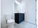 Modern bathroom with dark vanity and white toilet at 2404 1/2 E Chelsea, Tampa, FL 33610