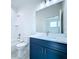 Bathroom with blue vanity, white toilet, and shower/tub combo at 2404 1/2 E Chelsea, Tampa, FL 33610