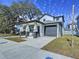 New construction home with a gray door and attached garage at 2404 1/2 E Chelsea, Tampa, FL 33610