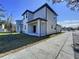 Side view of house with a small yard and sidewalk at 2404 1/2 E Chelsea, Tampa, FL 33610