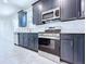 Modern kitchen with dark cabinets and stainless steel appliances at 2404 1/2 E Chelsea, Tampa, FL 33610