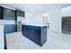 Large kitchen island with white countertop and dark blue cabinets at 2404 1/2 E Chelsea, Tampa, FL 33610